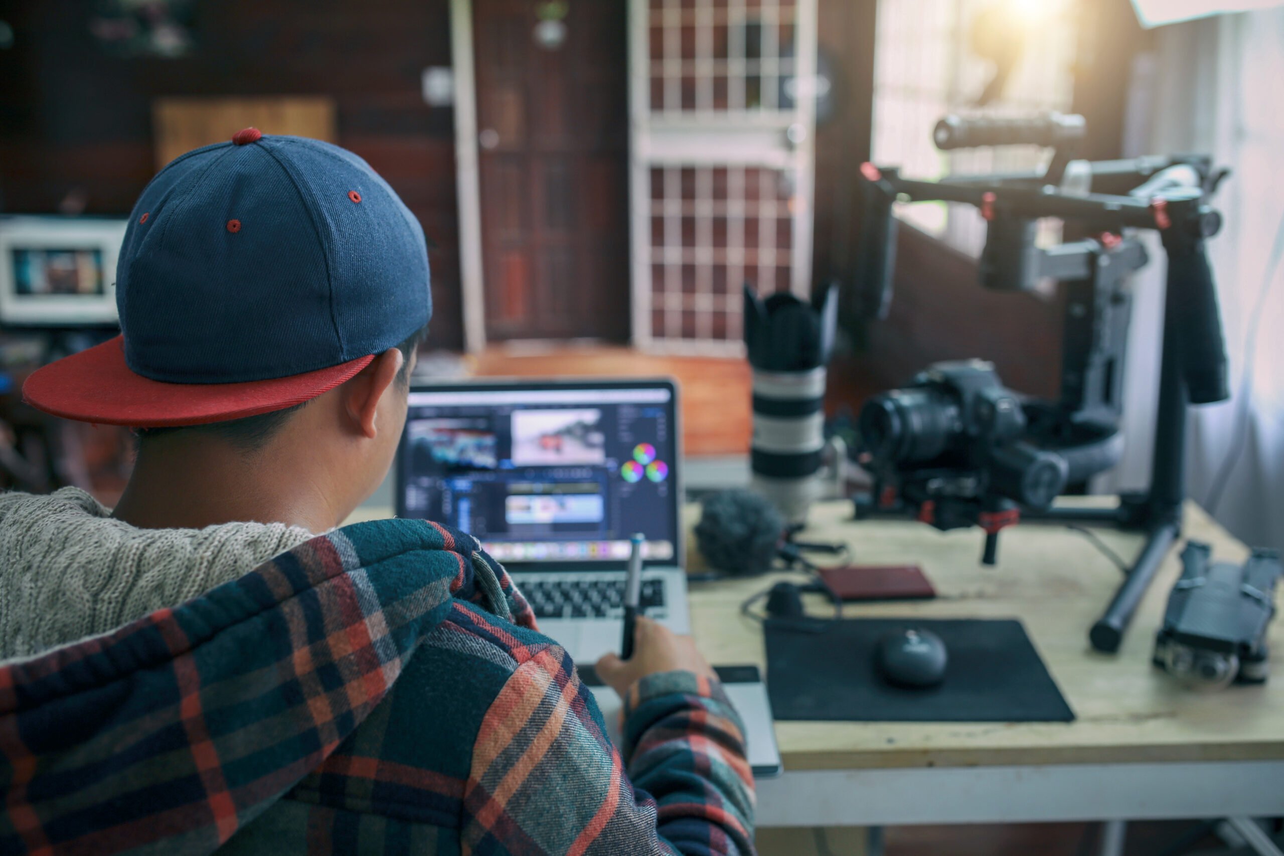 Young contractor man editing video on laptop for uploading video to internet online or social media.