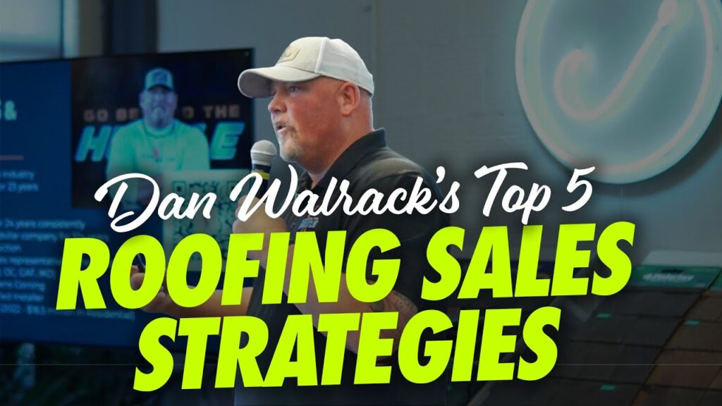 On stage, Dan Walrack presents his Top 5 Roofing Sales Strategies. He addresses the audience with a microphone, while roofing materials and a presentation screen are visible in the background.