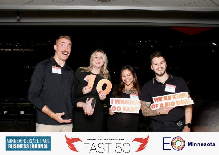 Hook Agency team celebrates at awards event, holding fun props; Fast 50 and key partner logos are clearly displayed.